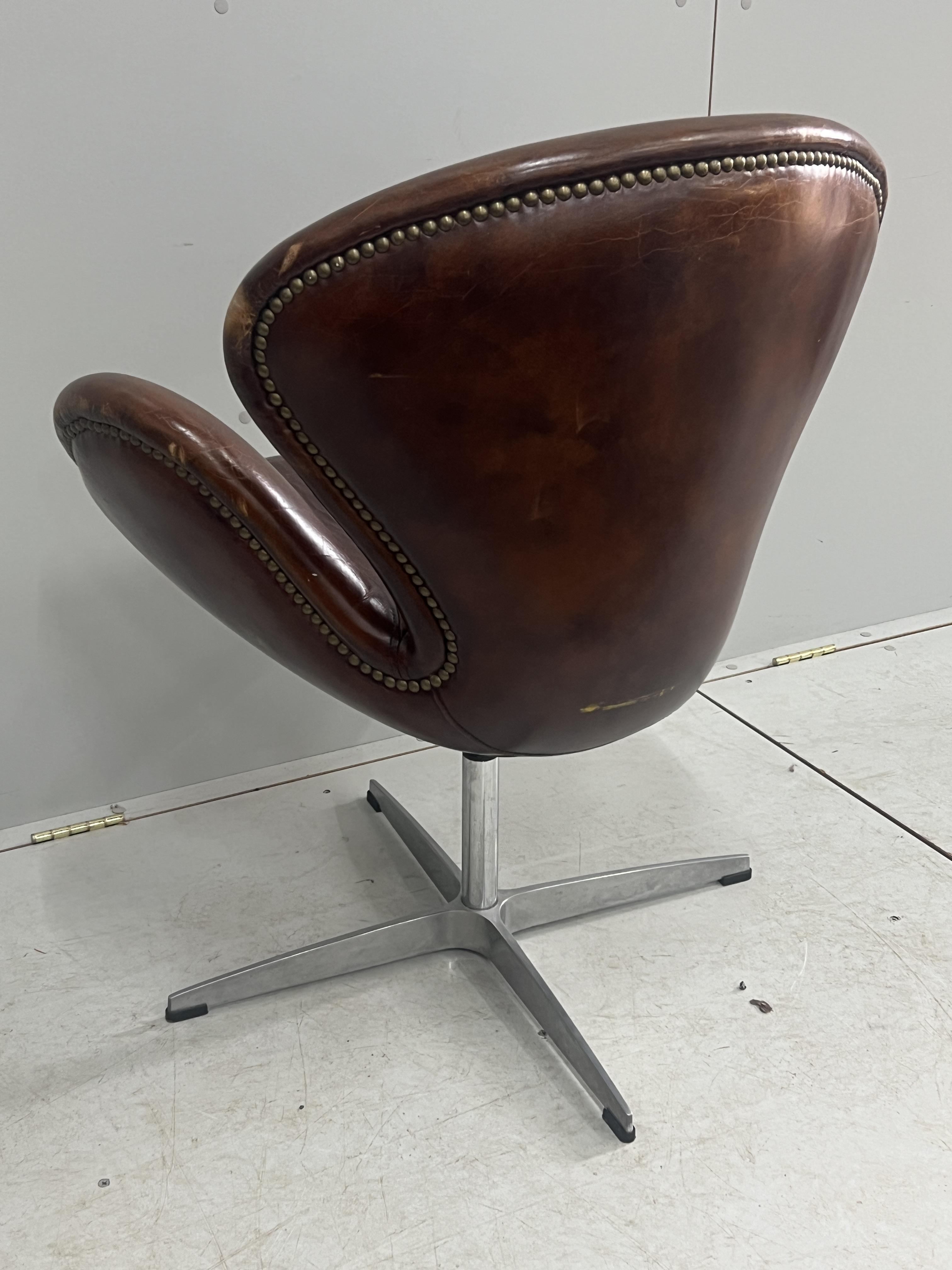 A tan leather petal chair, width 70cm, depth 42cm, height 84cm